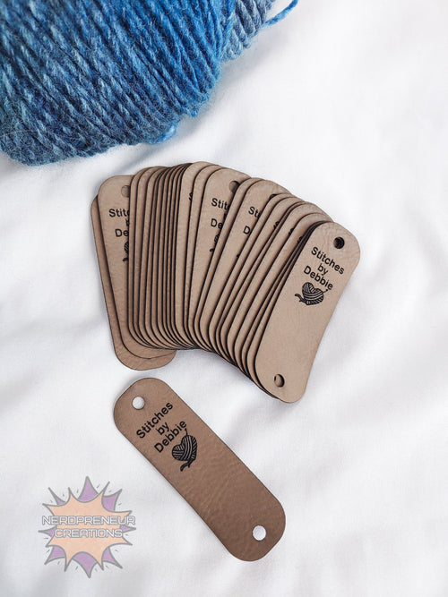 Set of brown faux leather tags with 'Stitches by Desire' branding on a white background.