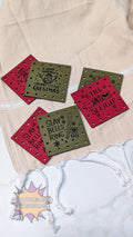 Set of three faux leather patches with text designs on a beige fabric background