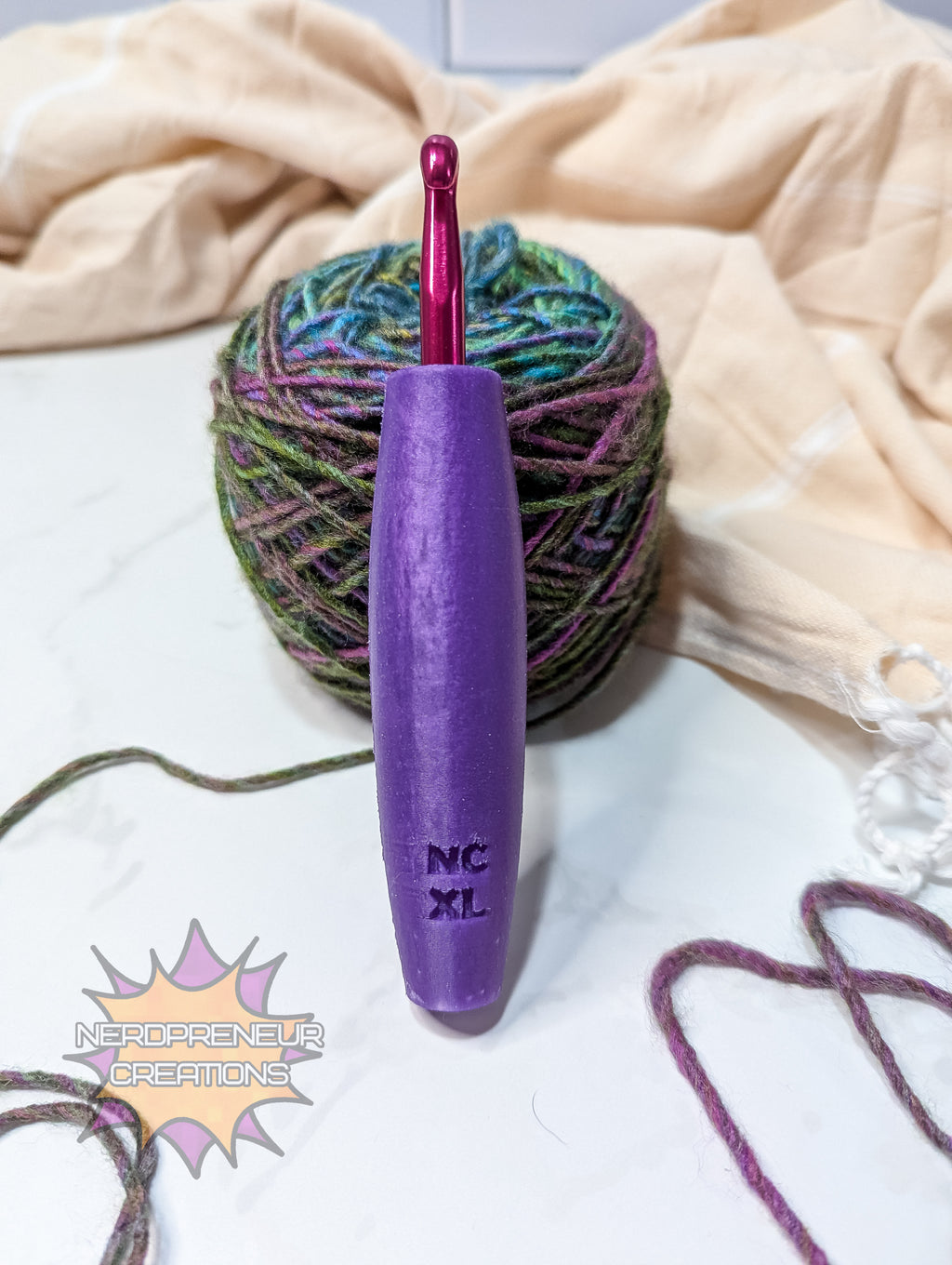 Purple crochet hook with a ball of yarn on a light background
