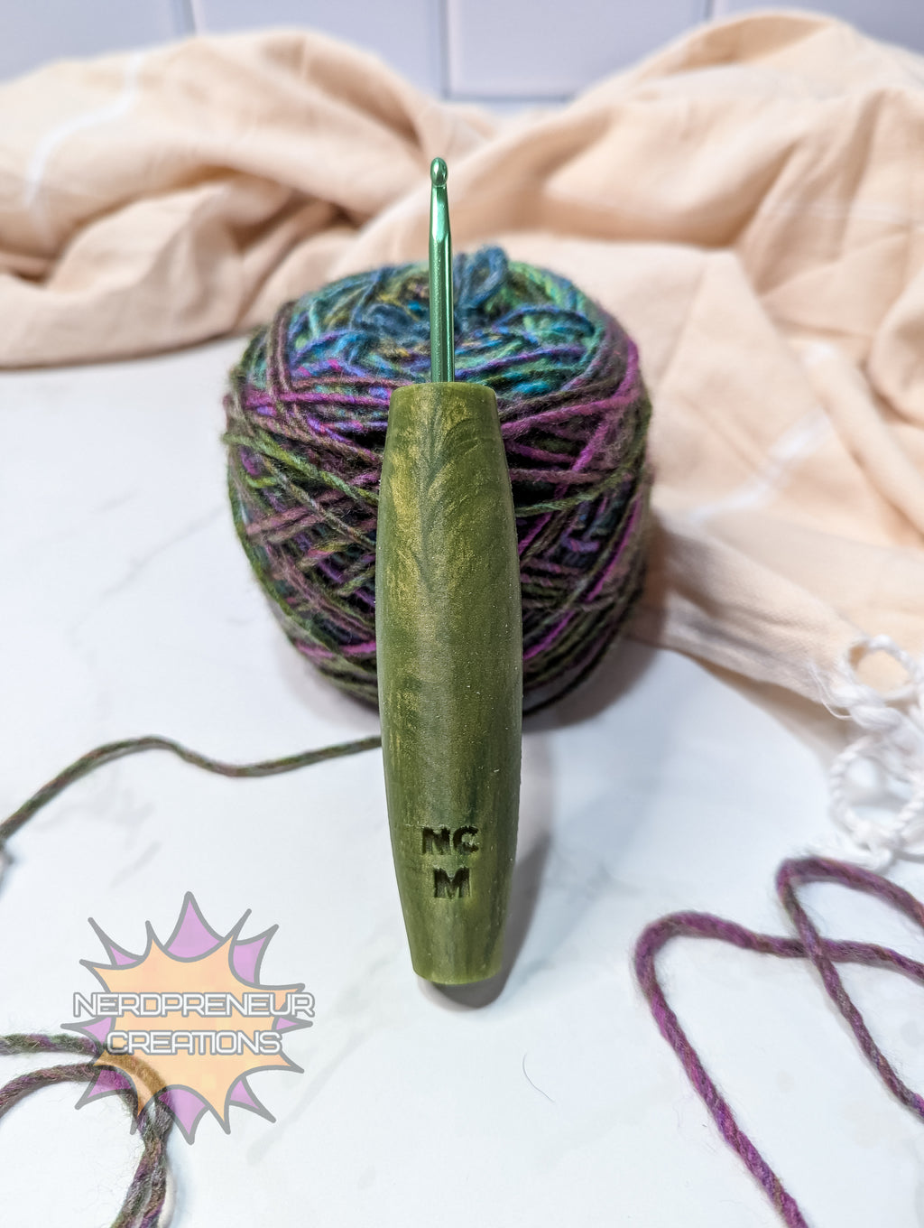 Green silicone crochet hook with yarn and colorful yarn ball on a light background