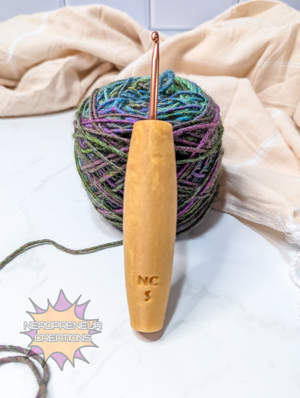 Crochet hook with silicone handle and colorful yarn on a light background