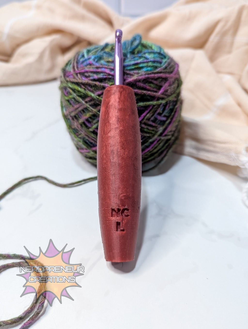 Silicone crochet hook with a ball of yarn on a light background