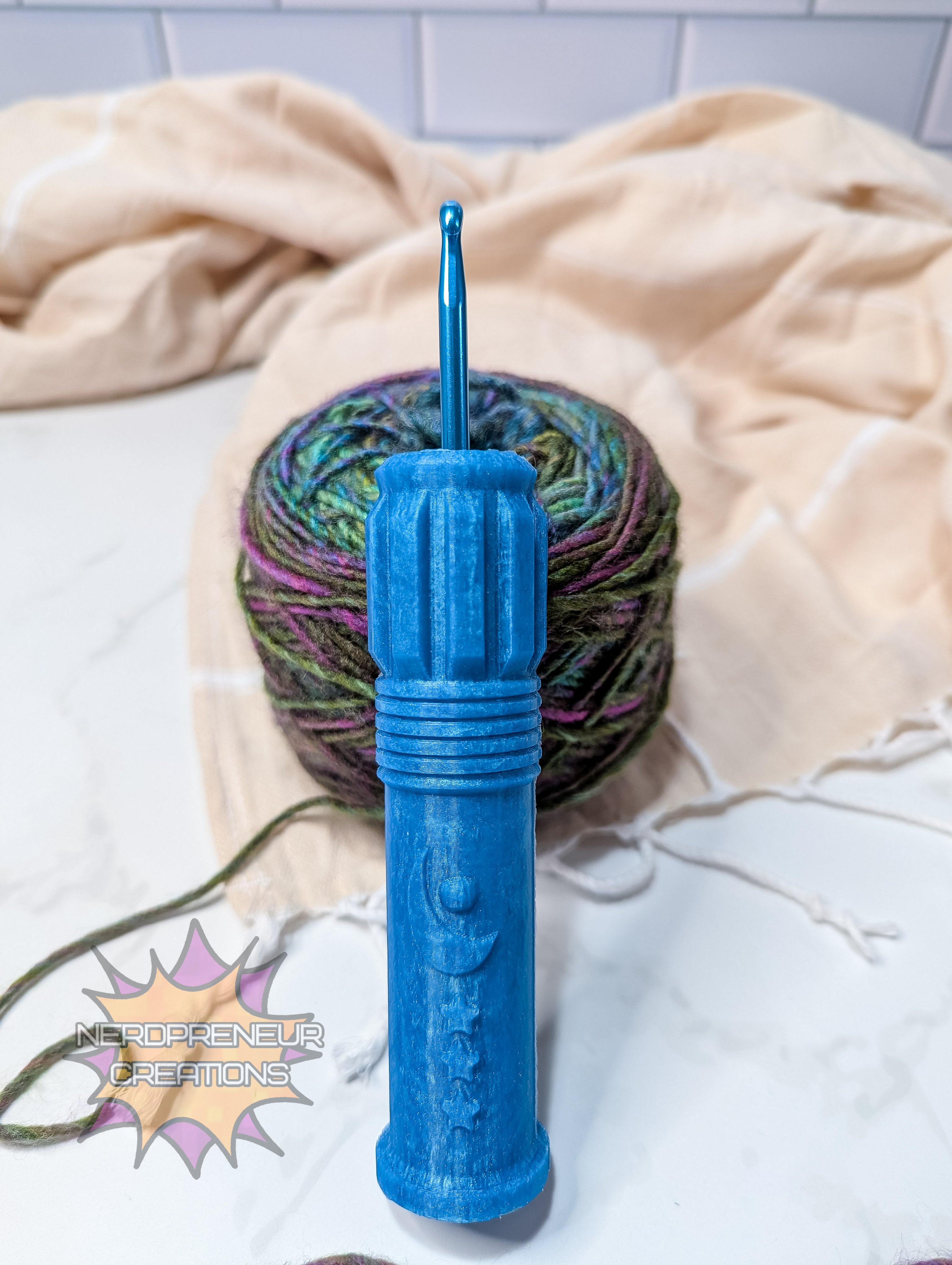 Blue silicone crochet grip with a ball of multicolored yarn on a light background