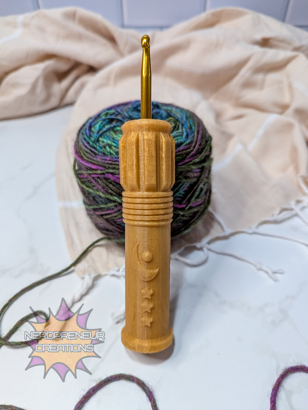 Gold silicone crochet grip with multicolored yarn on a light background
