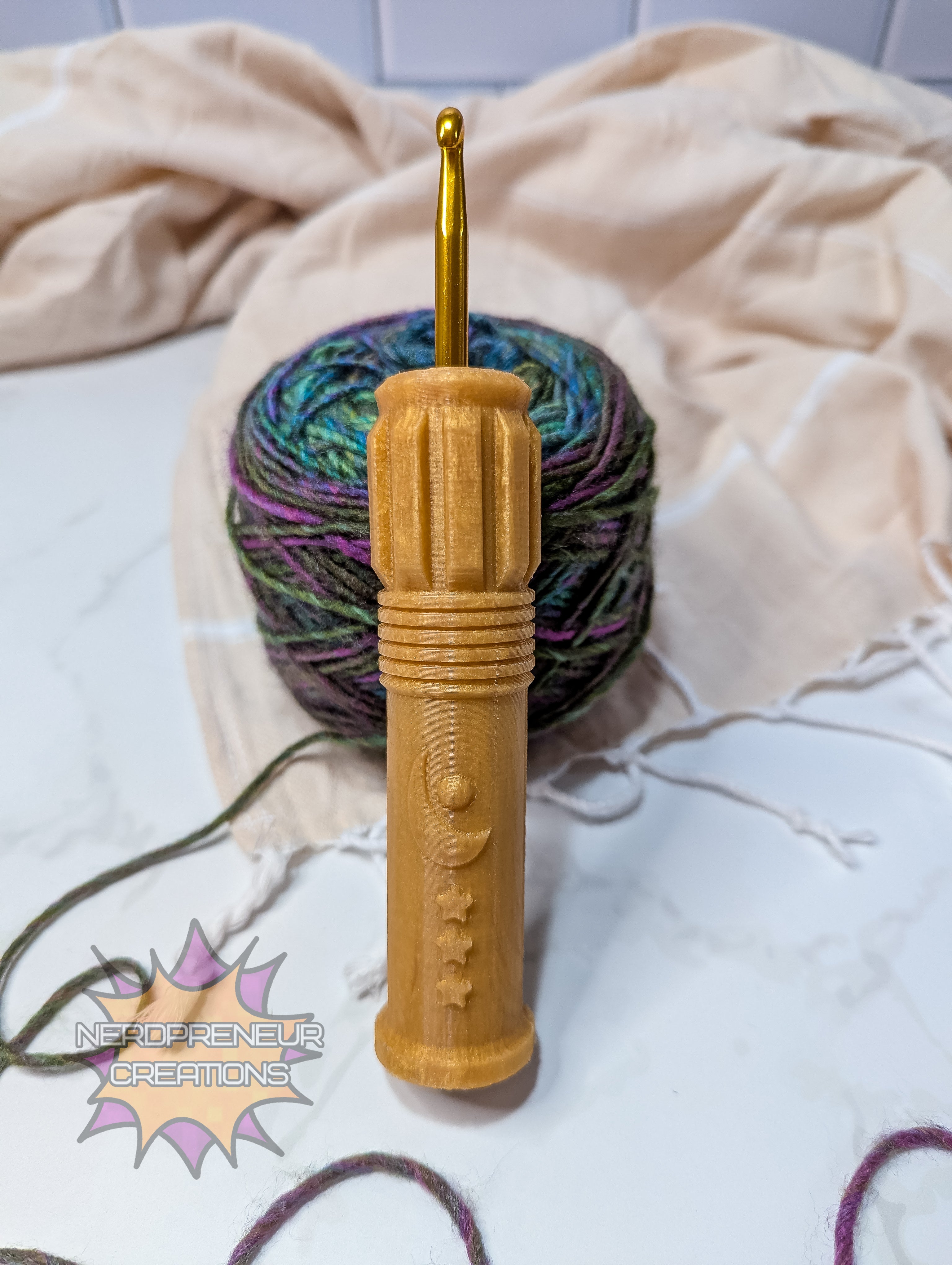 Gold silicone crochet grip with multicolored yarn on a light background