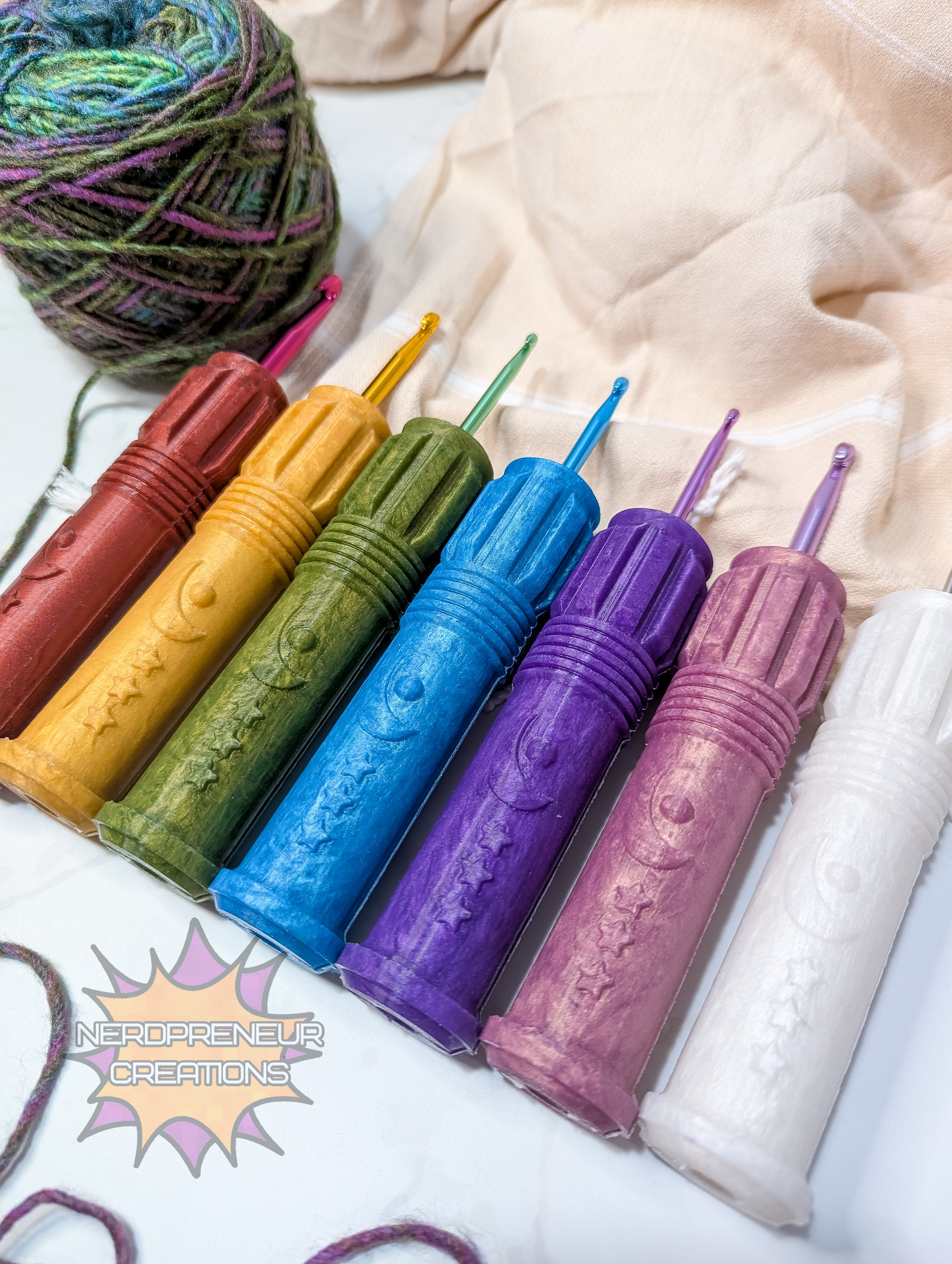 Set of colorful silicone crochet grip with a ball of yarn on a textured fabric background.