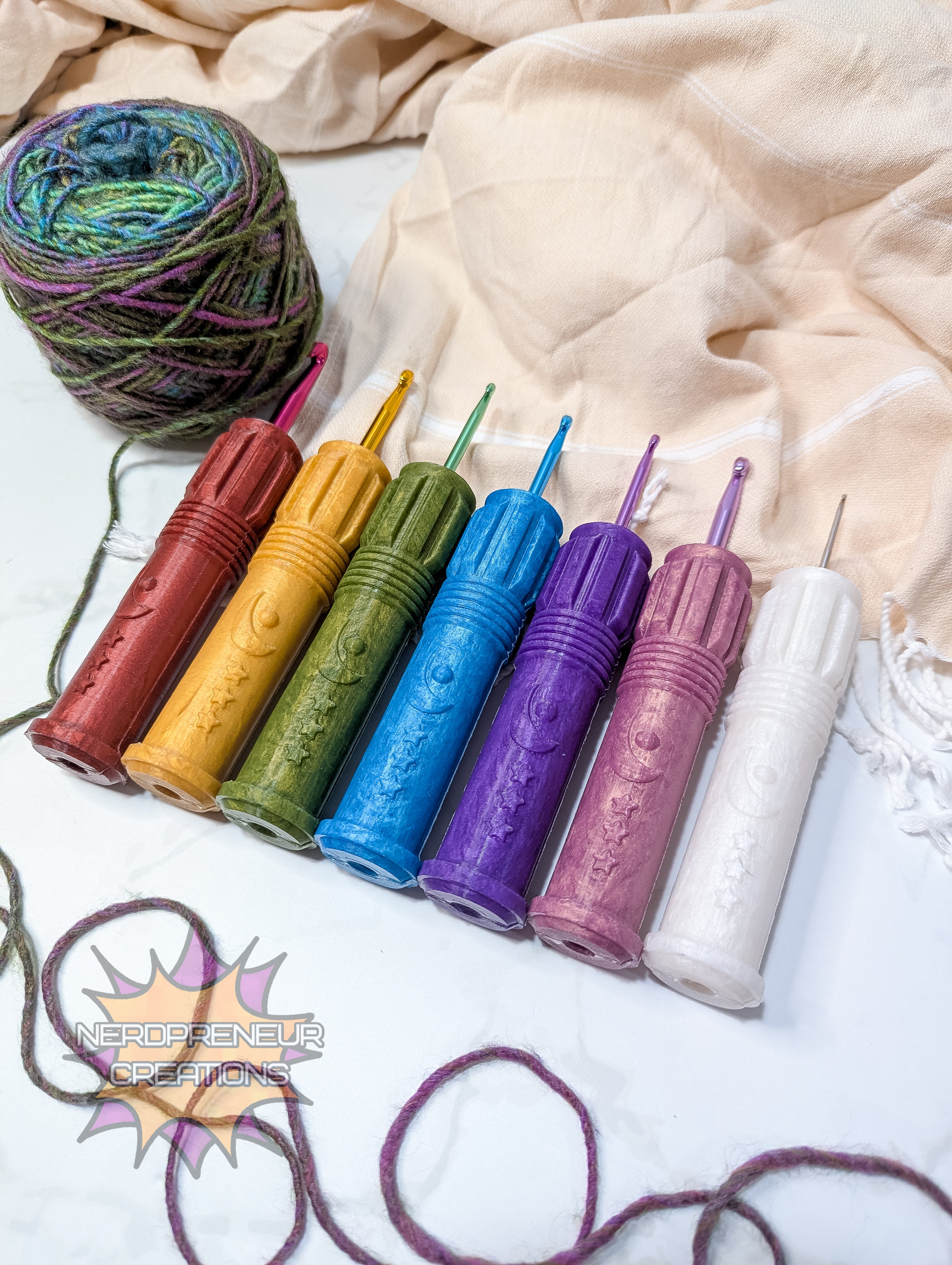 Set of colorful silicone crochet grips on a textured fabric background with yarn.