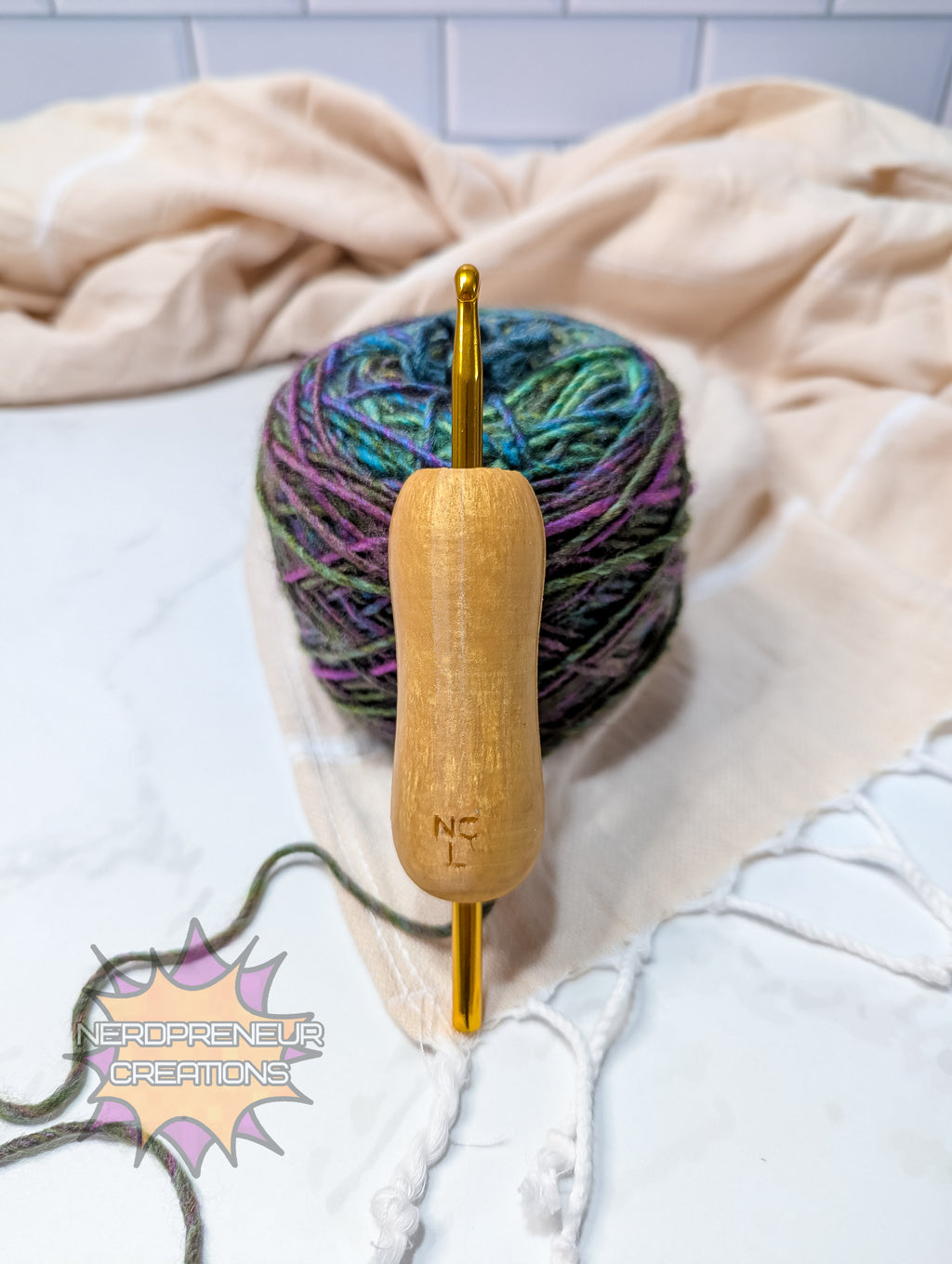 silicone crochet grip with a ball of yarn on a white surface with a beige towel
