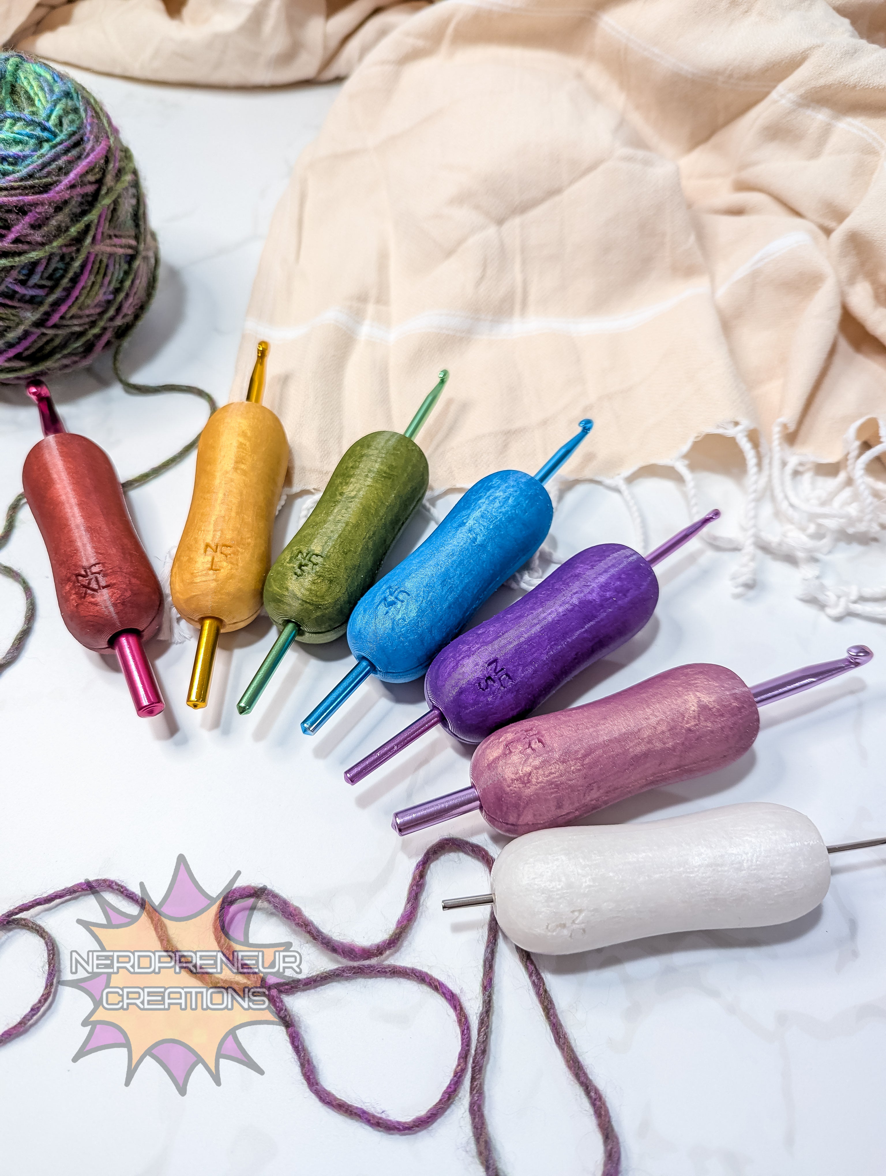 Colorful silicone crochet grips on a textured fabric background with 'Nordic Yarn Creations' branding.