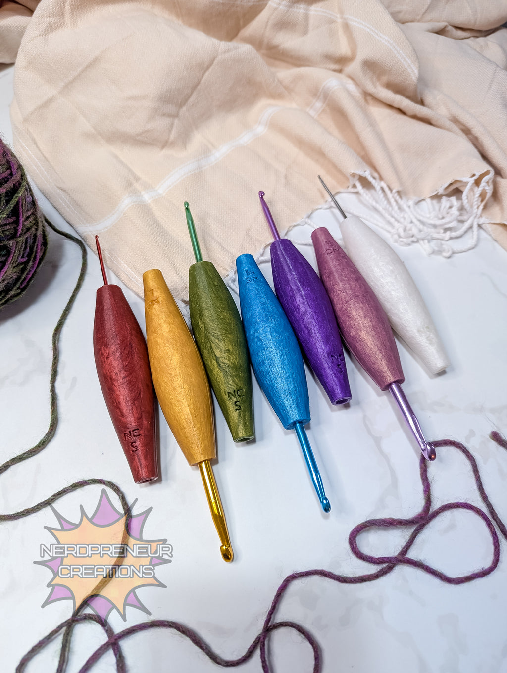 Set of colorful silicone crochet grips on a textured fabric background with 'Nordicpreneur Creations' logo.
