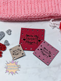 Red and pink faux leather patches with 'You're my favorite player' text on a white surface with pink fabric in the background.