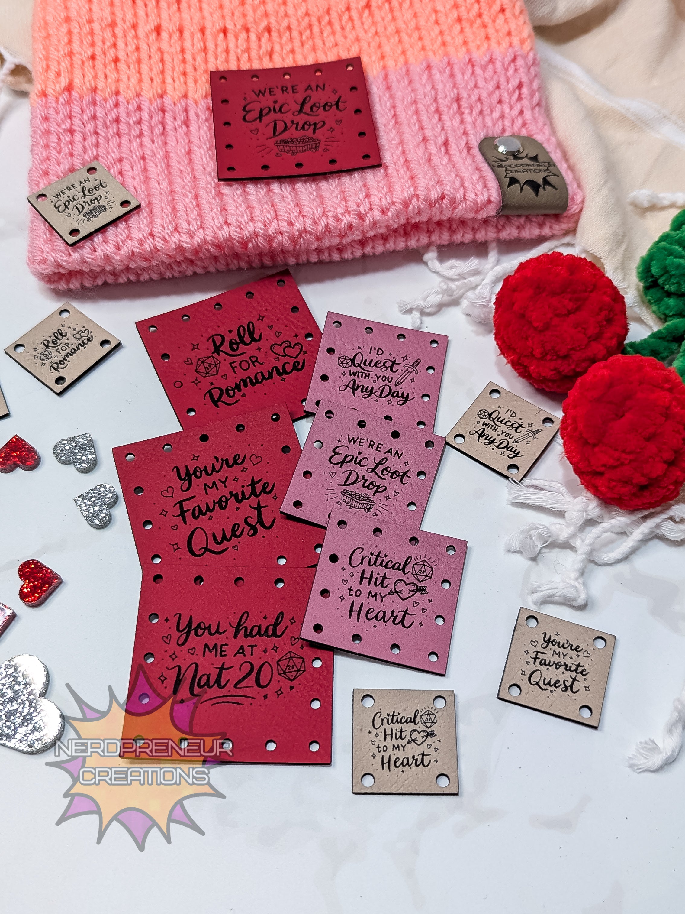 gamer faux leather patches with romantic sayings on a white background with a pink knitted item.