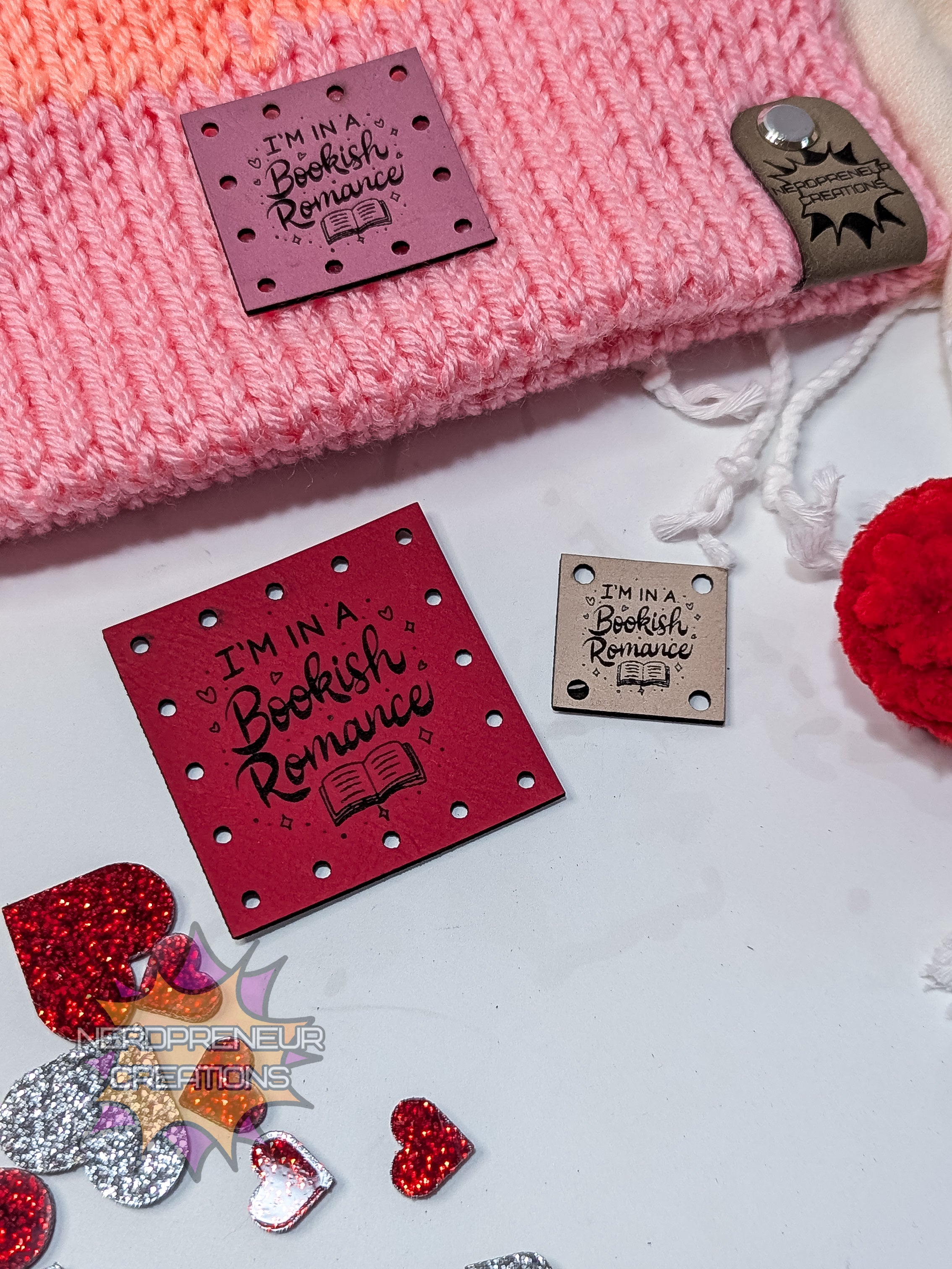 Pink faux leather patches with 'I'm in a Bookish Romance' patches on a white background