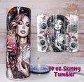 Set of 4 tumblers with various designs on a wooden surface