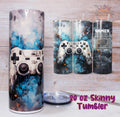 Set of tumblers with gaming controller design and 'Gamer' label on a wooden surface.